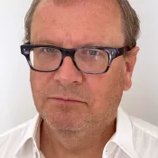 portrait of person with glasses and a white shirt