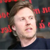 portrait of man In black shirt with black and red background