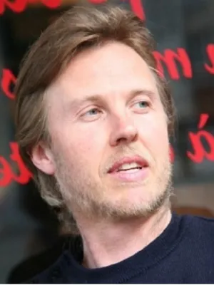 portrait of man In black shirt with black and red background